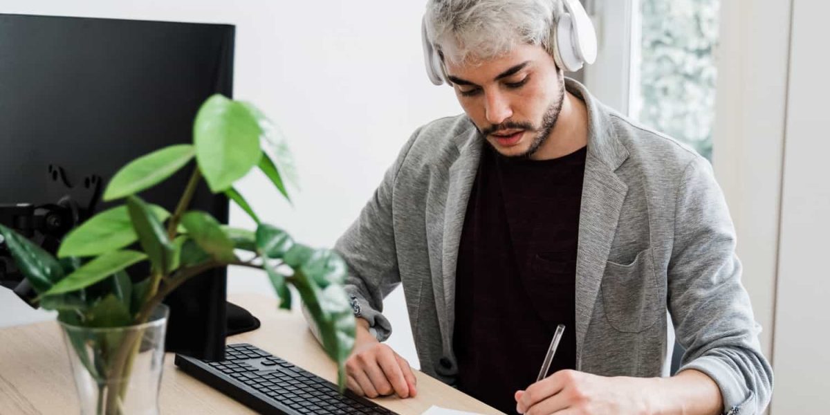 young-hipster-man-using-computer-and-headphones-wh-2021-06-01-05-57-15-utc-min.jpg